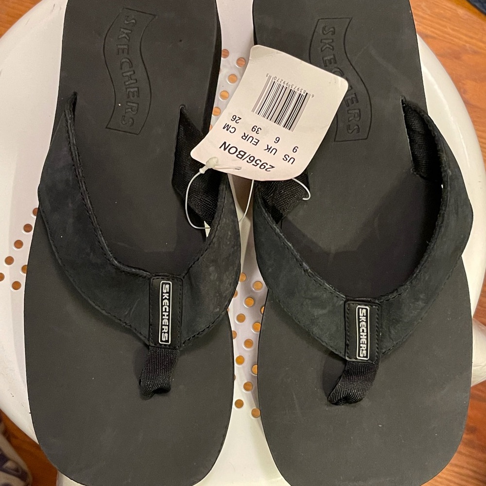 Black sketcher flip flops